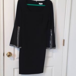 Size 6 black crepe dress rhinestone on sleeves .